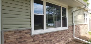Beige house siding and stone veneer on home exterior